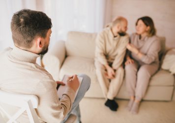 Psychiatrist consultinig couple that have problems in their relationship. Mental support session. Psychiatrist consultinig couple that have problems in their relationship. Mental support session.