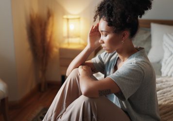 Sad, tired and woman with thinking in bedroom of insomnia, depression and remember memory of trauma Sad, tired and woman with thinking in bedroom of insomnia, depression and remember memory of trauma